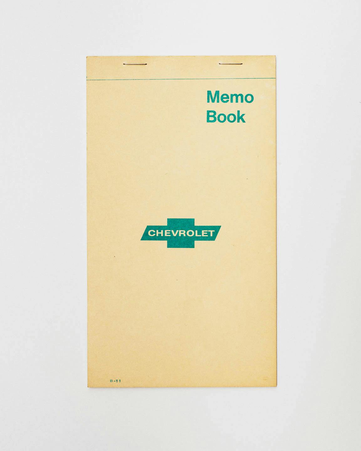 A yellow envelope with the Chevrolet logo that reads "memo book" in the upper-right corner.